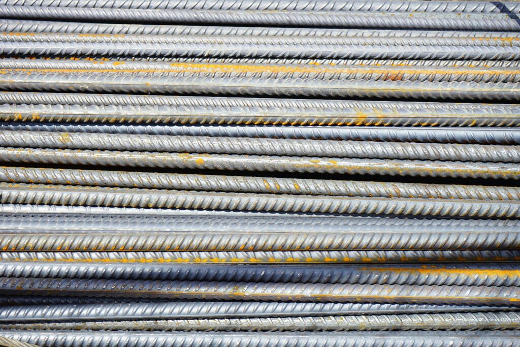 Close-up of stacked rusty steel reinforcing bars used in construction.